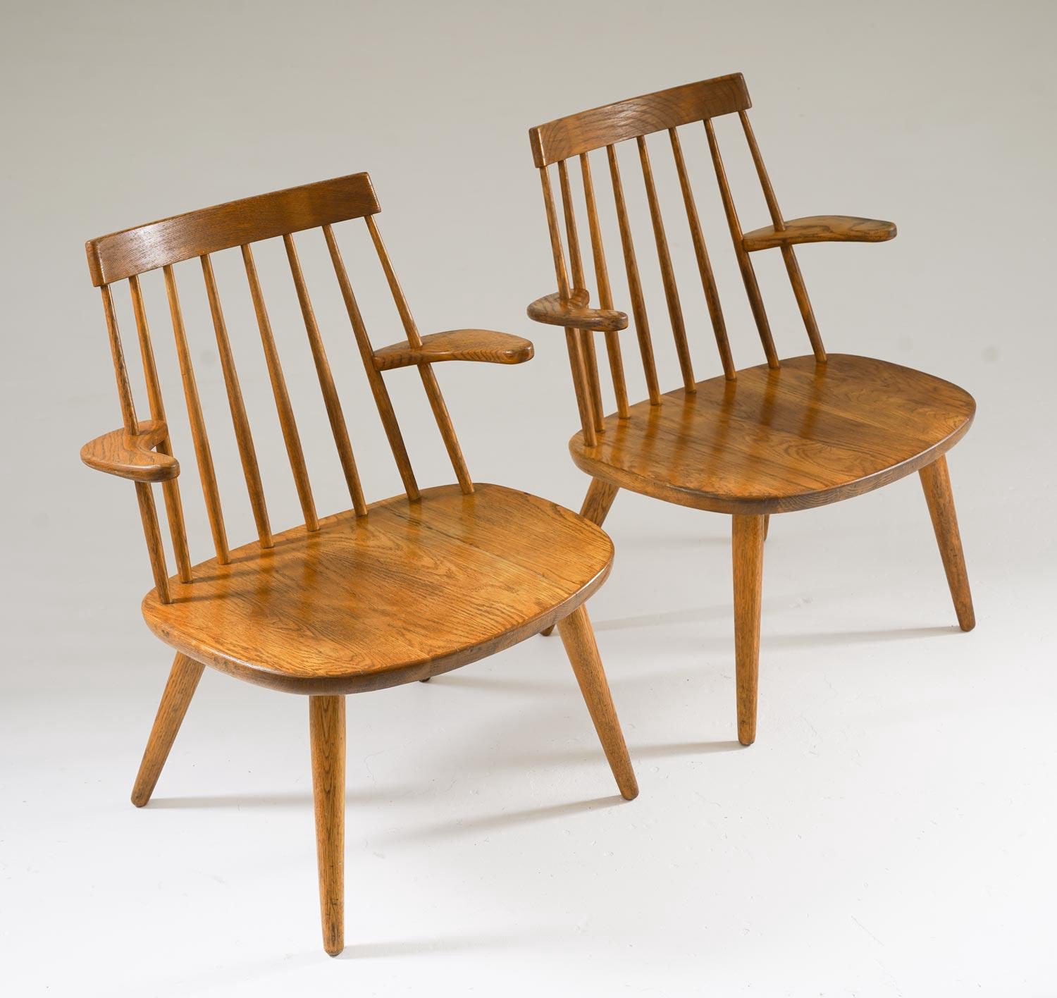 Swedish armchairs, model "Sibbo," designed by Yngve Ekström in the 1950s. Crafted from oak, these chairs showcase Ekström's signature balance of form and function. The spindle backrest and sculpted armrests provide both comfort and visual lightness,