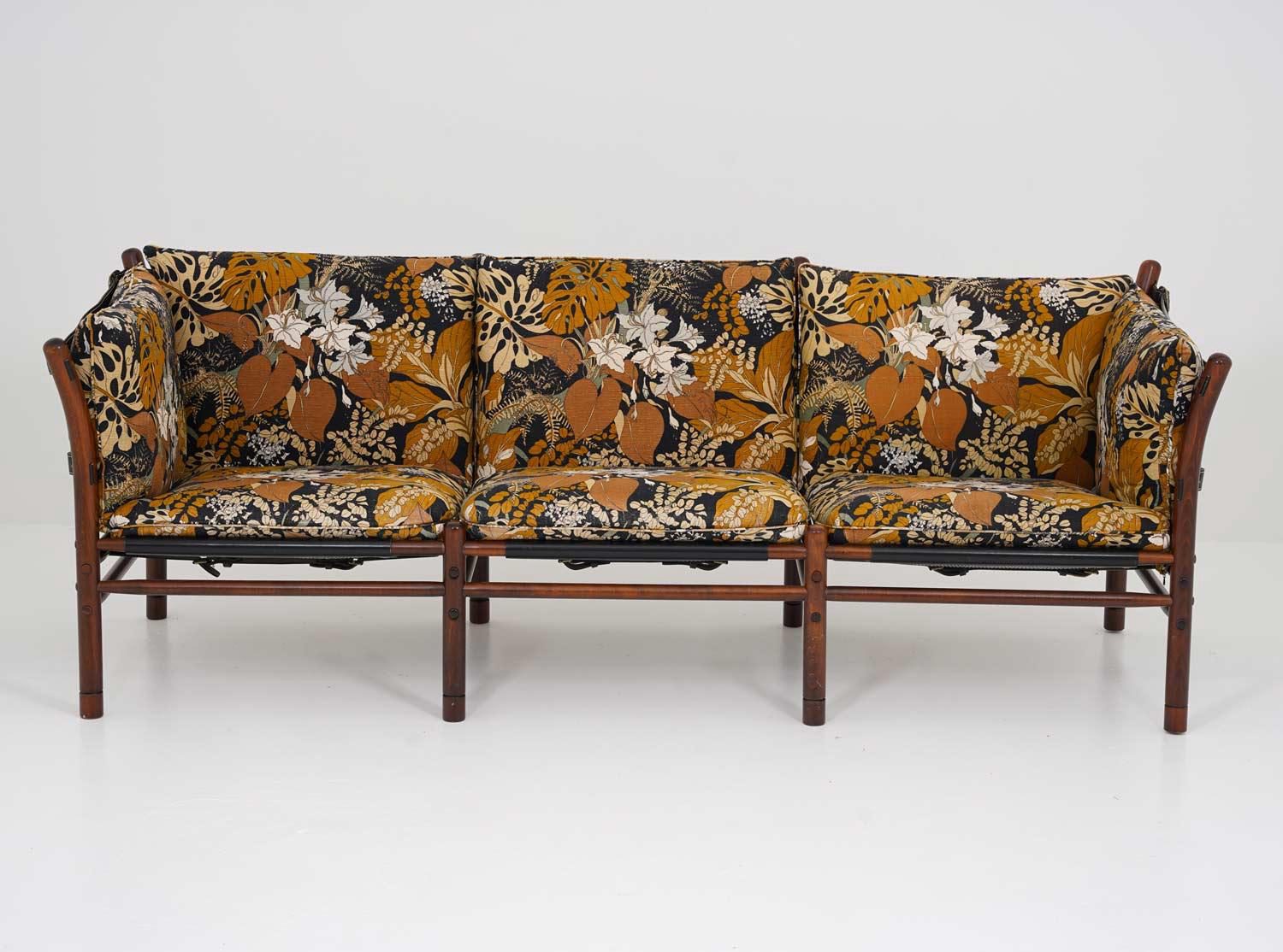 This striking "Ilona" sofa was designed by renowned Swedish designer Arne Norell and produced during the 1970s. Constructed from stained beech wood, the frame features Norell’s hallmark craftsmanship: a visible construction with strong, rounded